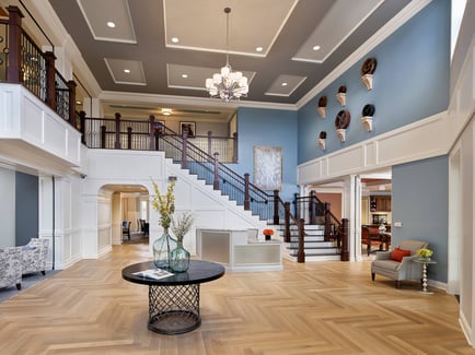 A high-ceiling lobby with a grand staircase