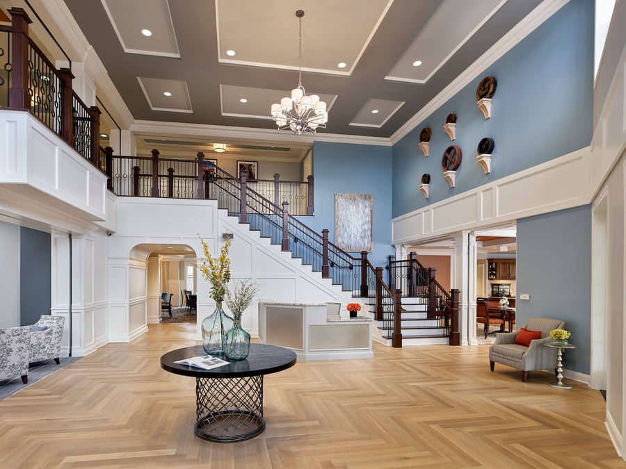 A high-ceiling lobby with a grand staircase