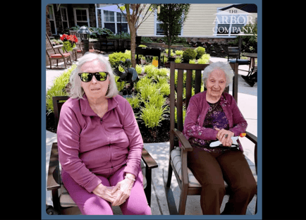 two senior ladies sitting outdoors