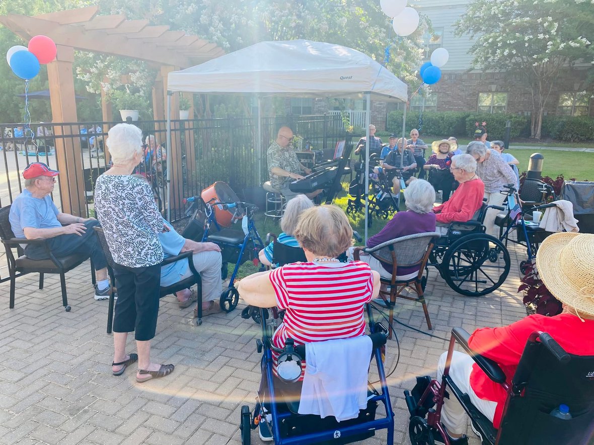 PTC residents on patio listening to live music