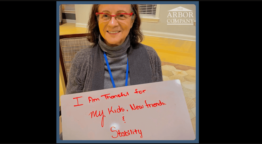 a senior lady holding a signage 