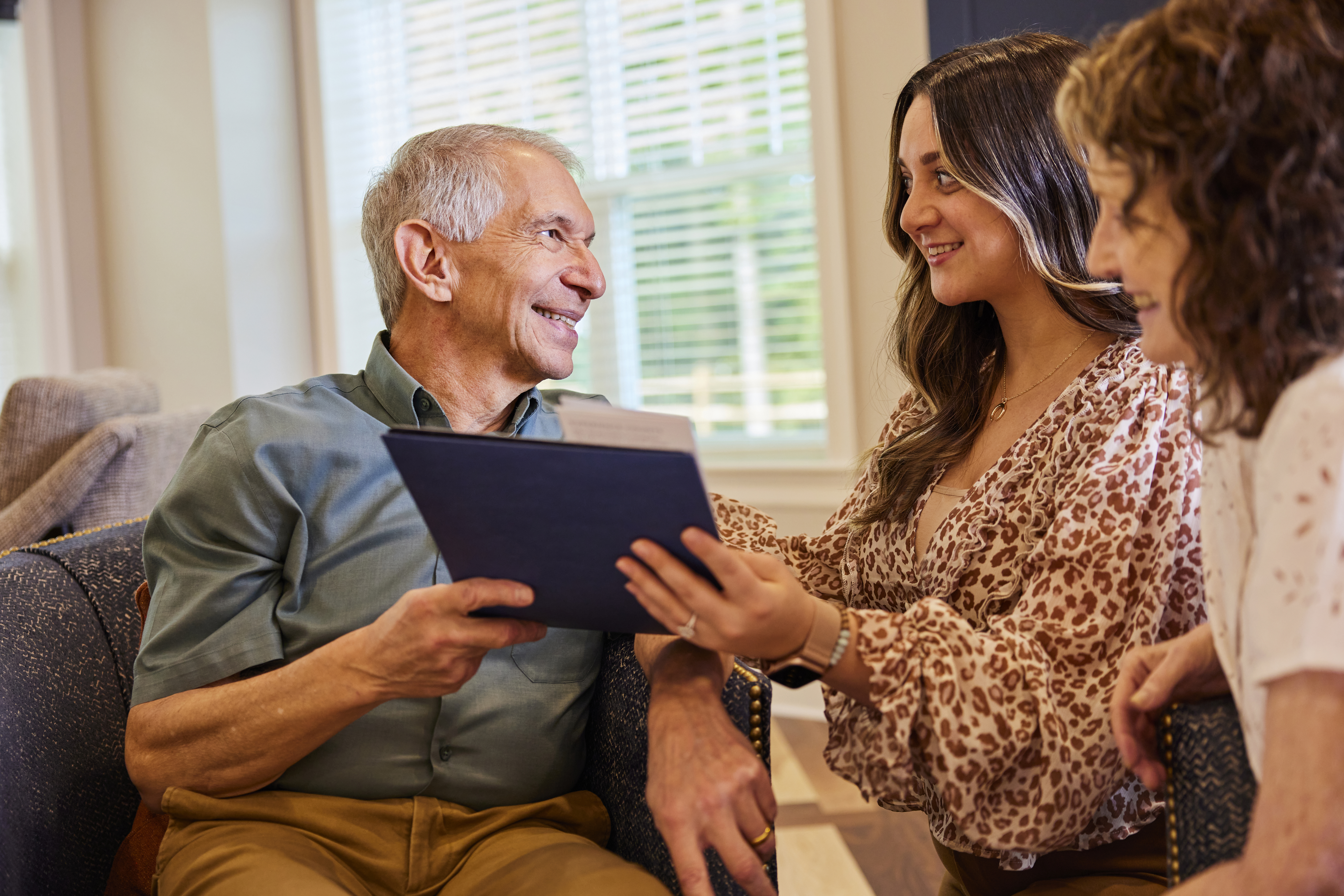 Staff member handing a resident an IPad