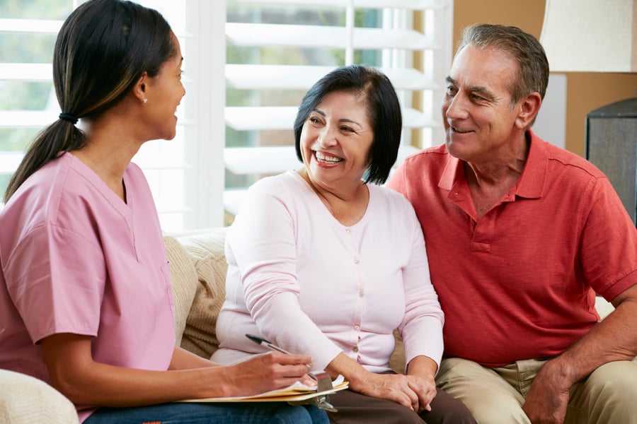 A staff member meets warmly with a couple during a consultation, reflecting the attentive, personalized approach families experience when evaluating assisted living communities in Miami, FL like Mirabelle.