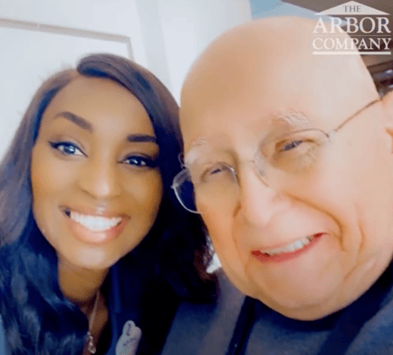 A staff member and a resident smile warmly together in a close, cheerful photo, reflecting the genuine bonds and compassionate senior care Marietta GA families trust at our senior living East Cobb community.