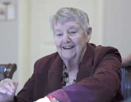 A resident laughs joyfully during what appears to be a group activity, capturing the vibrant and engaging senior lifestyle offered at this Acworth, GA community.