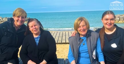 Four Women in Assisted Living at the beach with Arbor Terrace Highland Park staff