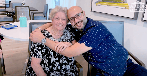 an employee hugging a senior lady