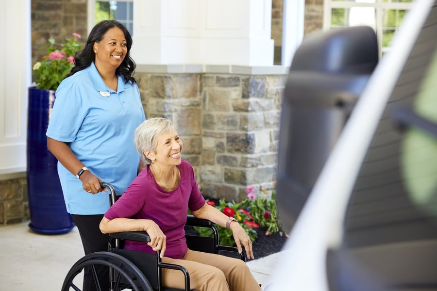 Assisted living resident being supported by staff member