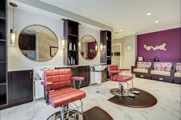 A calming salon with plush chairs and elegant mirrors highlights the resort-style senior living amenities and wellness programs available in Glenview, IL.