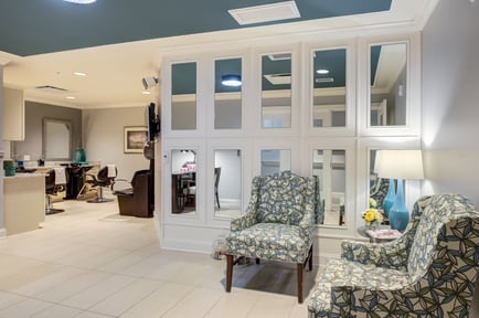 The on-site salon and styling area at Arbor Terrace Morris Plains features salon chairs, mirrors, and a cozy seating nook, reflecting the resort-style senior living amenities available in Morris Plains, NJ.