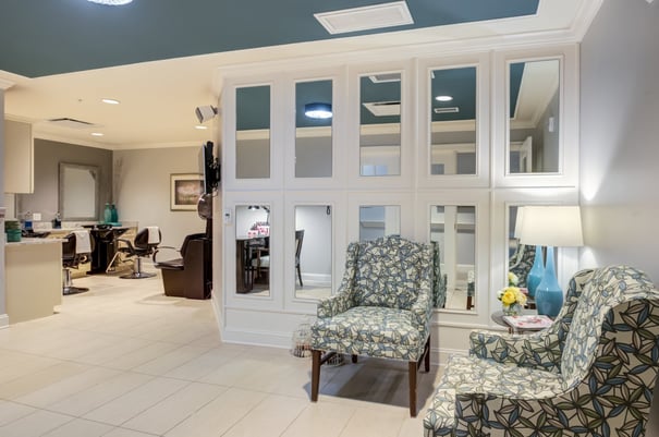 The on-site salon and styling area at Arbor Terrace Morris Plains features salon chairs, mirrors, and a cozy seating nook, reflecting the resort-style senior living amenities available in Morris Plains, NJ.