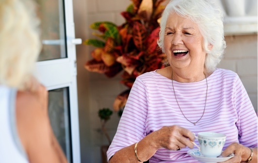 Exton resident smiling having tea