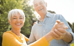 Senior couple smiling and dancing