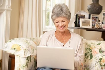 Senior using computer to calculate senior living cost