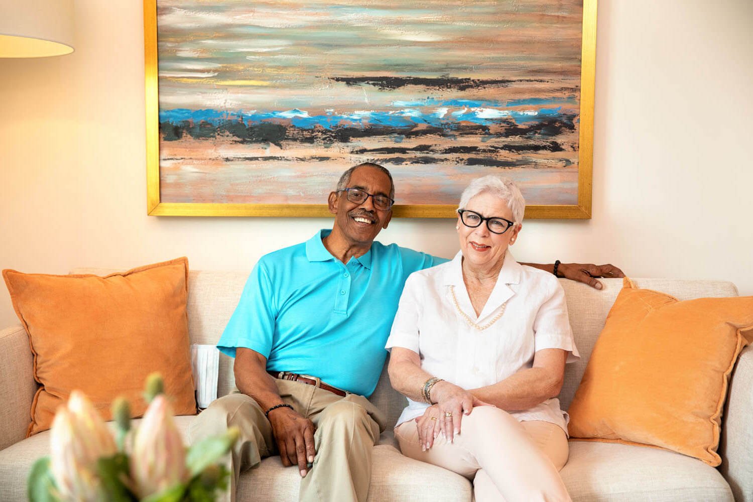 two senior citizens sitting on couch