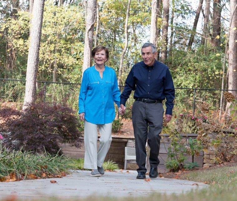 elderly couple walking together
